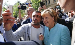 A migrant takes a selfie with German Chancellor Angela Merkel outside a refugee camp near the Federal Office for Migration and Refugees after registration at Berlin's Spandau district, Germany September 10, 2015. (Fabrizio Bensch/Reuters)